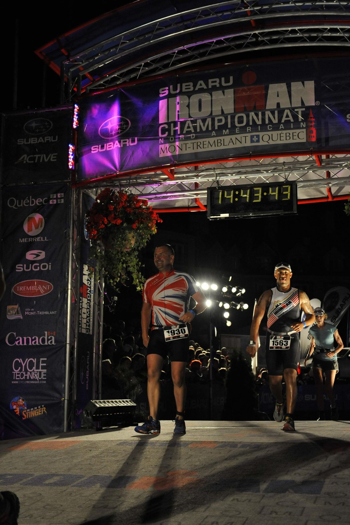 Yasir Salem crossing an Ironman finish line at night