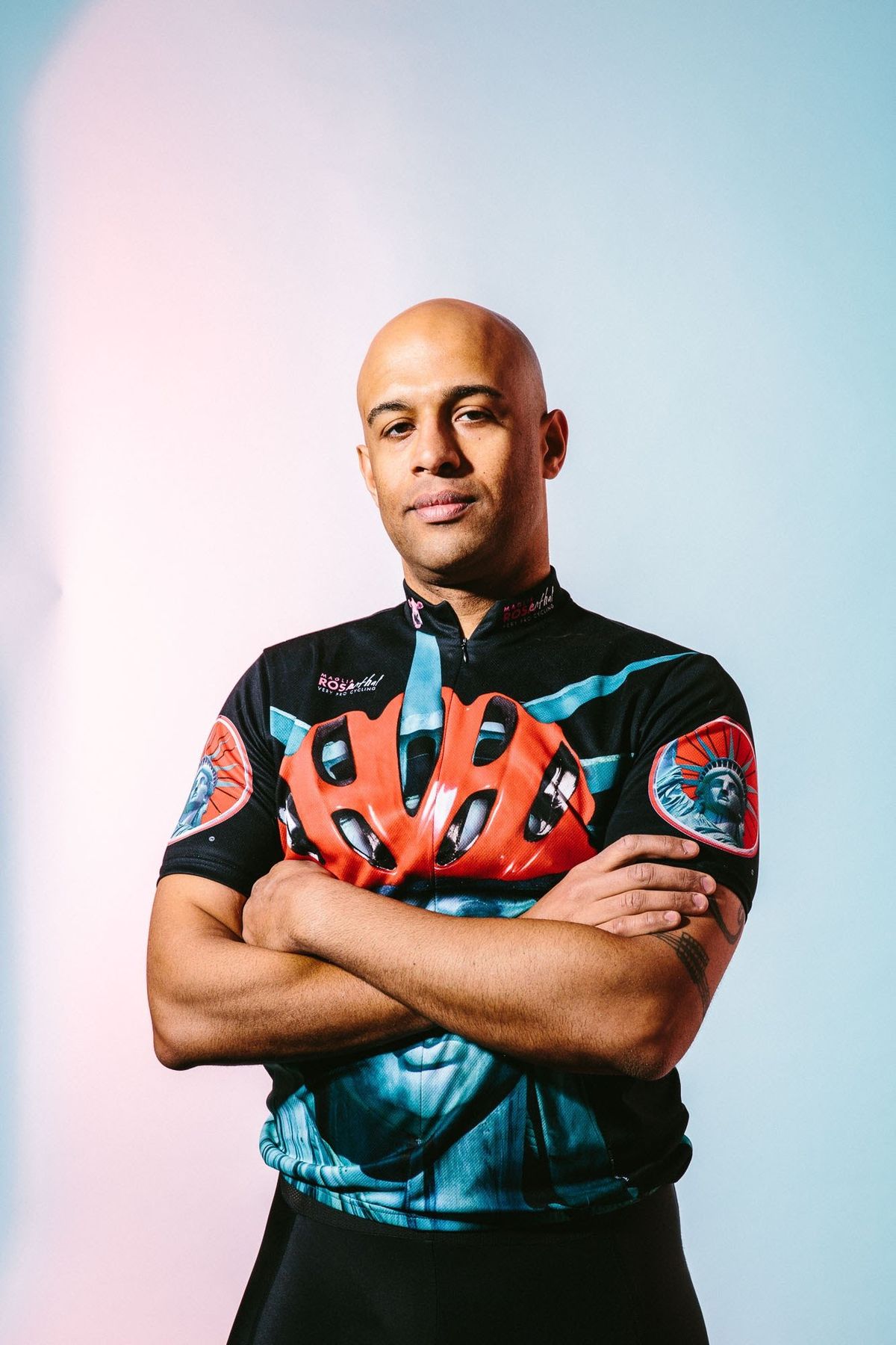 Yasir Salem with arms crossed in a Statue of Liberty cycling jersey
